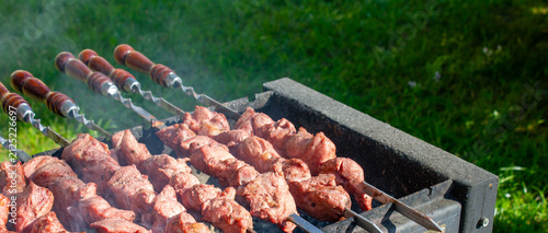 Grilling pieces of meat on skewers over a charcoal grill. Cooking a traditional shashlik over charcoal. Cooking meat on vacation authentic image wallpaper