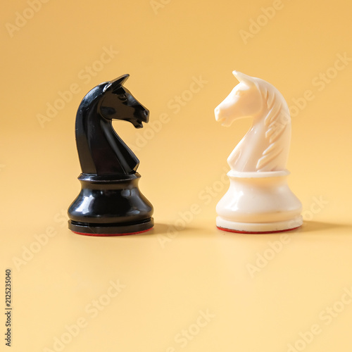 Black and White chess knight horse piece on color background.Business game.