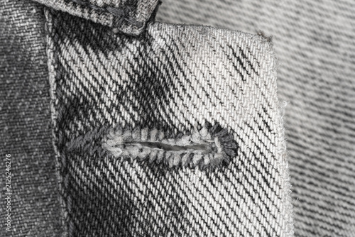 Obraz na plátně Closeup of buttonhole on grey denim jacket