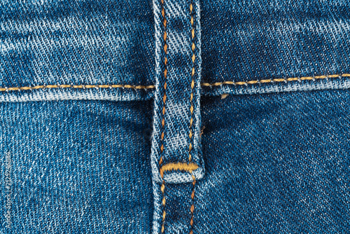 Cuadro en lienzo Blue denim jeans texture with belt loop and orange stitching macro detail