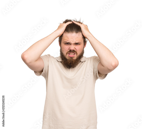 Stressed bearded young man clutching his head in frustration isolated on transparent background, anxiety, panic, emotional overload and mental stress concept.
