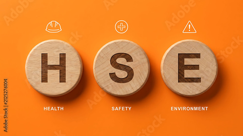HSE Health Safety Environment acronym wooden block concept on orange