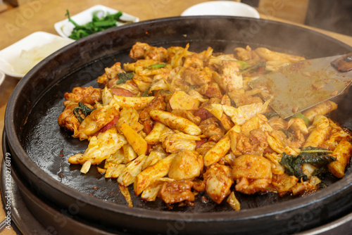 Spicy Korean Chicken Stir Fry Dakgalbi with Vegetables on Iron Pan