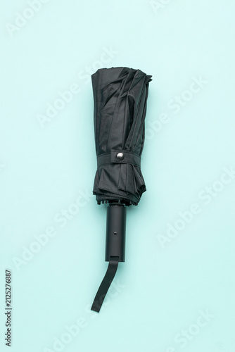 Canvas Print Folded Black Umbrella on Minimalist Pastel Background in Modern Stock Photograph