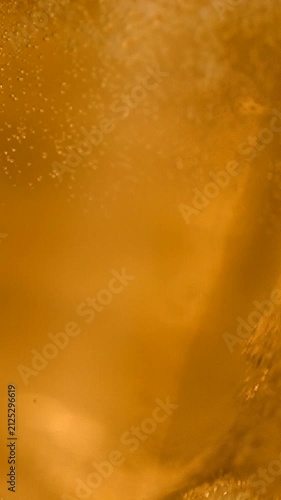 Cinematic slow-motion pouring shot of golden craft beer filling a glass, with creamy foam, sparkling carbonation and rich amber tones. Premium microbrewery IPA and lager aesthetic for brewing.