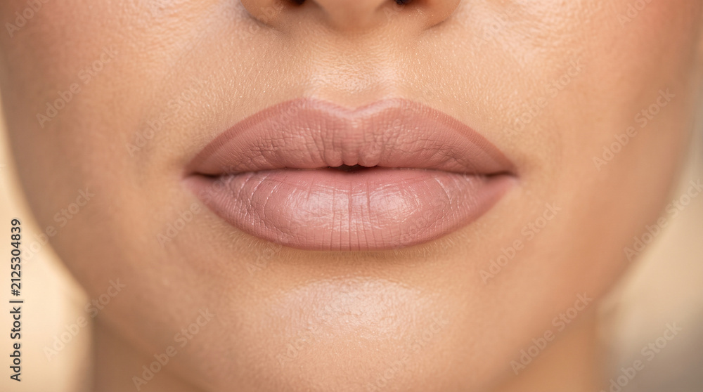 Fototapeta premium Extreme close-up of a woman's lips with natural lipstick, showing the texture of the skin, ad social media download thambnail poster web template event festival 2026 2027 2028