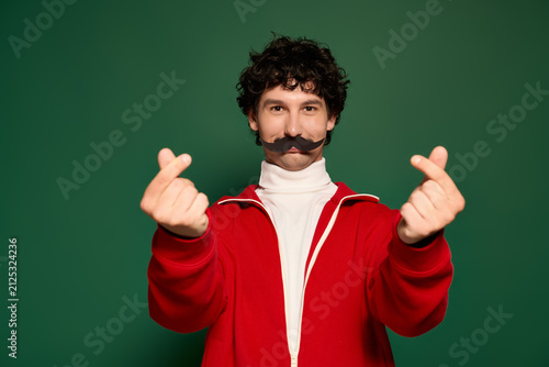 Obraz na plátně Young man with charming moustache embraces Movember celebration in a vibrant set