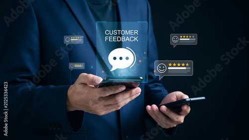 Man holding smartphone displaying customer feedback interface with star ratings and chat bubbles