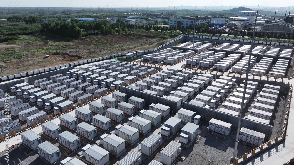 Fototapeta premium Large-scale energy storage station with rows of battery container units arranged in orderly formation