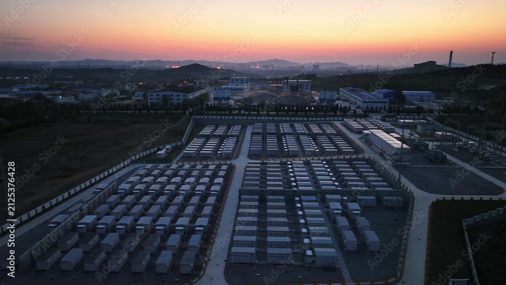 Fototapeta premium Large logistics warehousing park at dusk with panoramic view of container yards and industrial facilities