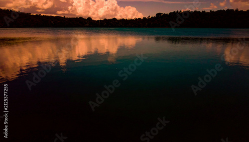 Panoramic lake water landscape pink evening clouds background
