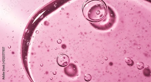 Pink liquid with bubbles closeup.