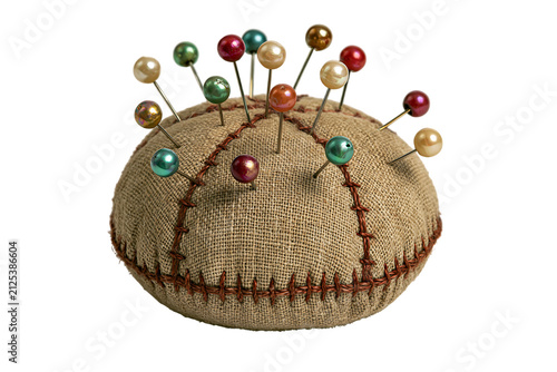 Round burlap pincushion with colorful pearl head sewing pins isolated on transparent background