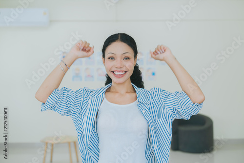 Fotografie Cheerful woman celebrating success happy female student feeling excited winner g