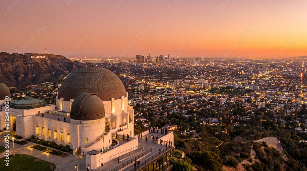 Fototapeta premium Griffith Observatory at Sunset: The iconic Griffith Observatory stands majestically against a vibrant sunset sky, overlooking the sprawling cityscape of Los Angeles.