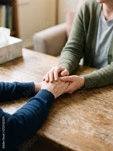 Close up view of supportive hands holding each other for emotional comfort