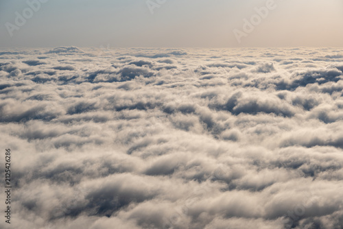 Endless Sea of Clouds Above the Horizon with Soft Atmospheric Sky.