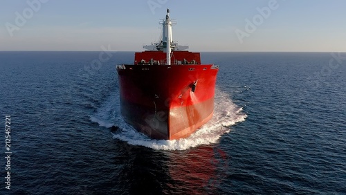 Great cargo ship sailing fast in open waters of the Mediterranean Sea close to the Spanish coast.