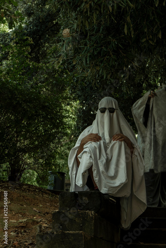 Person in Ghost Costume Sitting in Forest