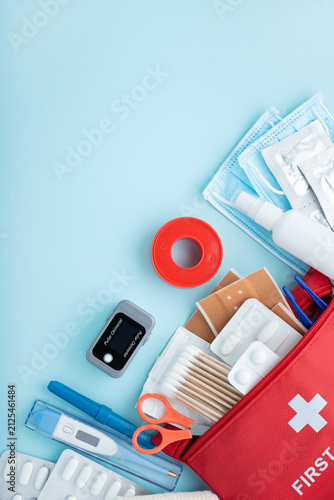 First aid kit contents arranged on light blue background