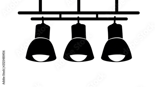 A trio of black track lights hanging from a rail, illuminating a space