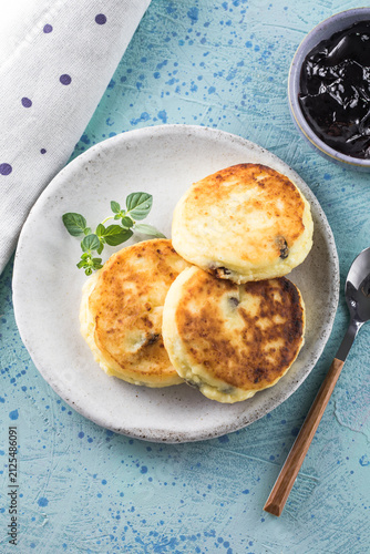 Sunday breakfast with cheesecake, jam. Cottage cheese pancakes or curd fritters decorated  jam