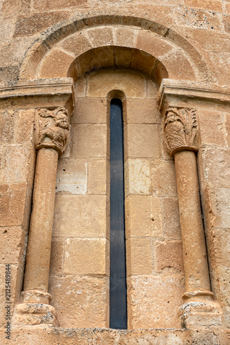 Fotografía Romanesque apsidal window framed by semicircular arch and historiated capitals o