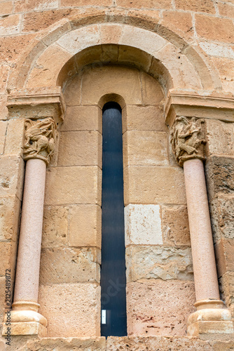 Fotografía Romanesque apsidal window framed by semicircular arch and historiated capitals o