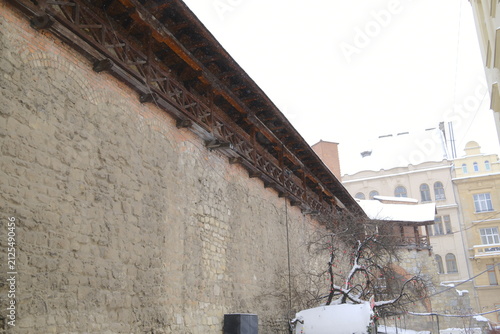 Canvas Print Ancient fortification walls of Lviv city showing wooden walkways covered by snow