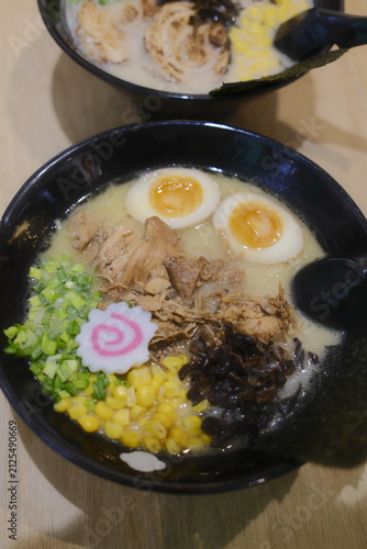 Фотография Steaming bowls of Japanese tonkotsu ramen featuring pork slices, soft boiled egg
