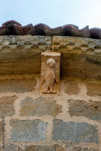 Принти на полотні Romanesque corbel depicting a carved bird figure on the eaves of the Church of S