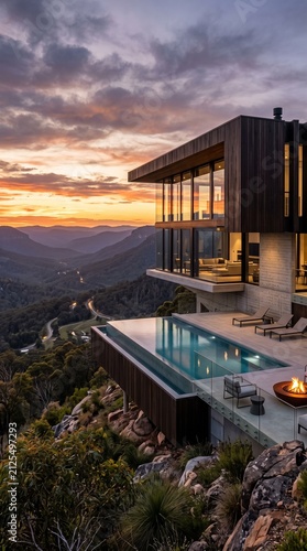 Modern luxury villa with infinity pool. Contemporary mountain house at sunset.