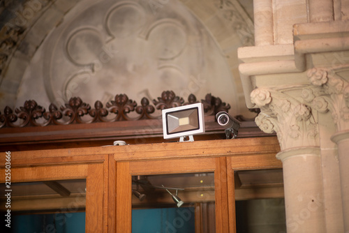Architectural details with security cameras on historical building facade
