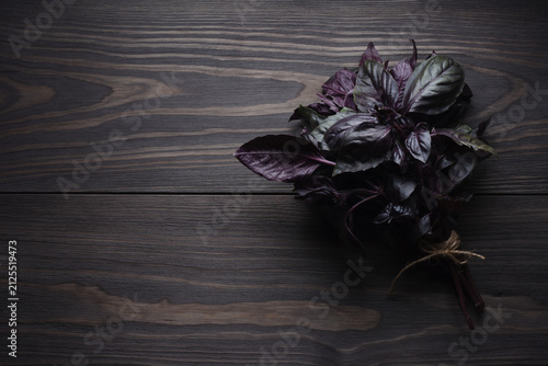Fresh bunch purple basil on dark wooden table