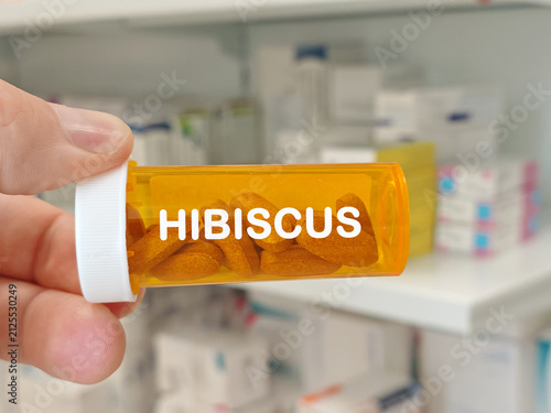 Quadro su tela HIBISCUS herbal supplement concept represented by brown compressed tablets in a