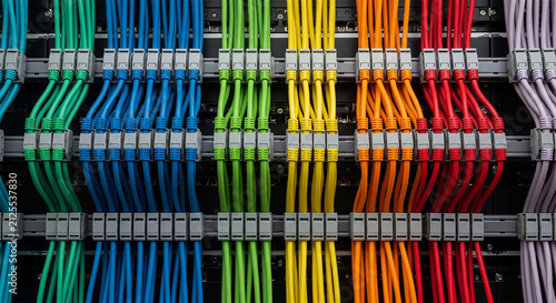 Colorful network cables in server rack, organized ethernet patch cords in data center, structured cabling system for telecommunications