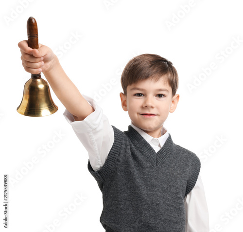 Cute boy ringing school bell on white background