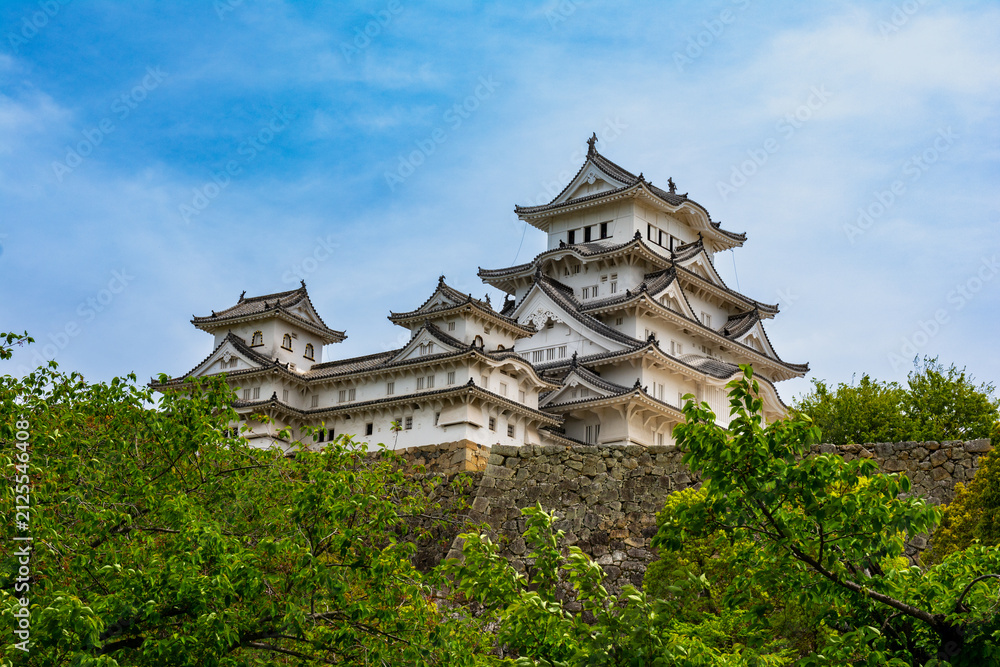 Naklejka premium The historic white Himeji Castle complex against a blue sky in Hyogo, Japan
