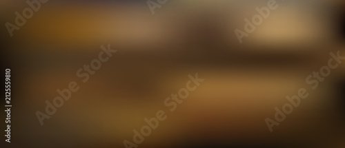 Blurred abstract background, with soft transitions, of dark brown, bronze, and golden tones