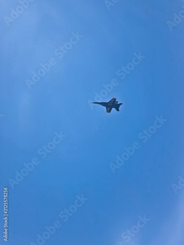 Blue Angels Fighter Jet Flying Through Clear Blue Sky with Copy Space