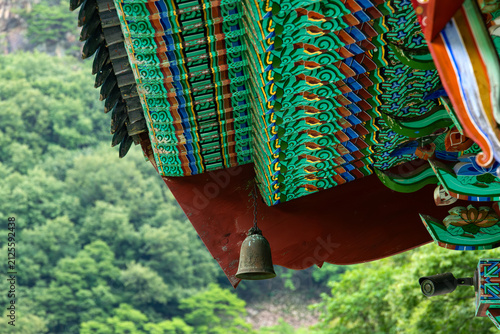 Obraz na plátně Ornate Dancheong temple eaves with wind chime bell and security camera