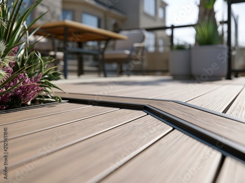 A contemporary outdoor setting featuring a modern composite deck board enhanced by a sleek black metal edge for a stylish look