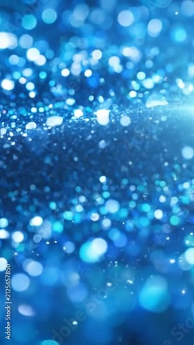 Abstract shimmering blue glitter background with soft bokeh lights and sparkling festive textures.