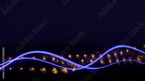Abstract light trails with glowing sparks in dark background for artistic design