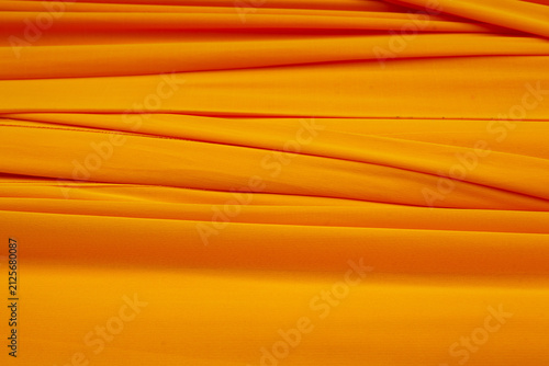 Obraz na plátně Traditional Buddhist yellow cloth draped elegantly