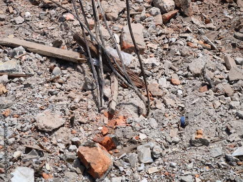 Industrial rubble and concrete debris scattered across a disaster site