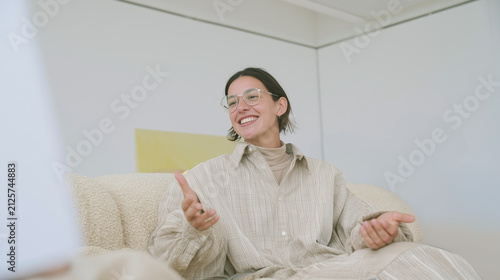Businesswoman gesturing during a casual conversation on a sofa