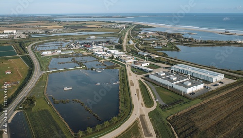 Aerial view of industrial aquaculture fish farm facility near coast
