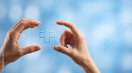 Healthcare wellness planning concept hands transparent medical cross blue background person human symbol health care protection support treatment medicine clinic hospital safety help service