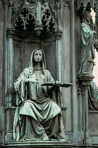 Photography Seated bronze figure on Historic Krizovnicke Square and Charles IV statue